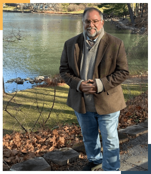 A man standing in front of a body of water.