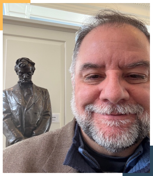 A man standing in front of a statue.